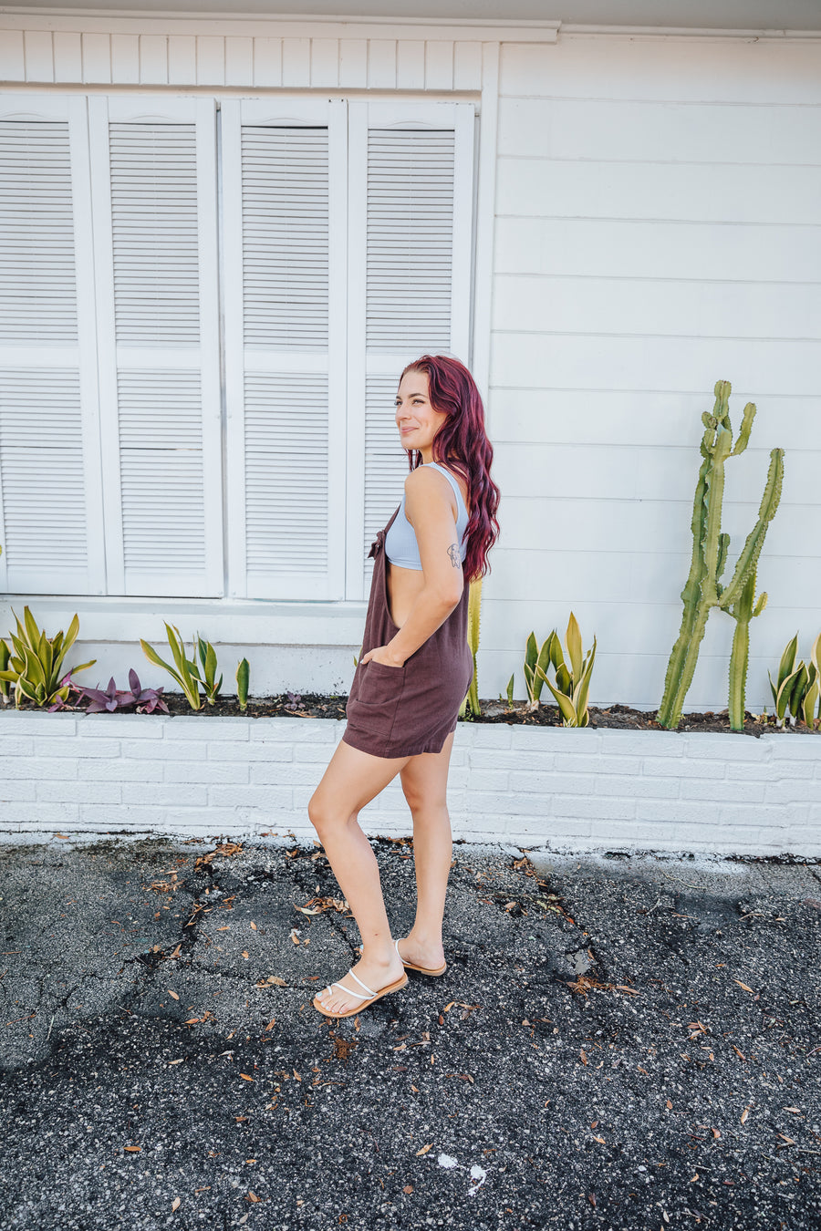 These trendy overalls have small straps that connect as knots to the straight neckline and have pockets along the bottom of the shorts. These brown overalls go perfect as a beach cover up.
