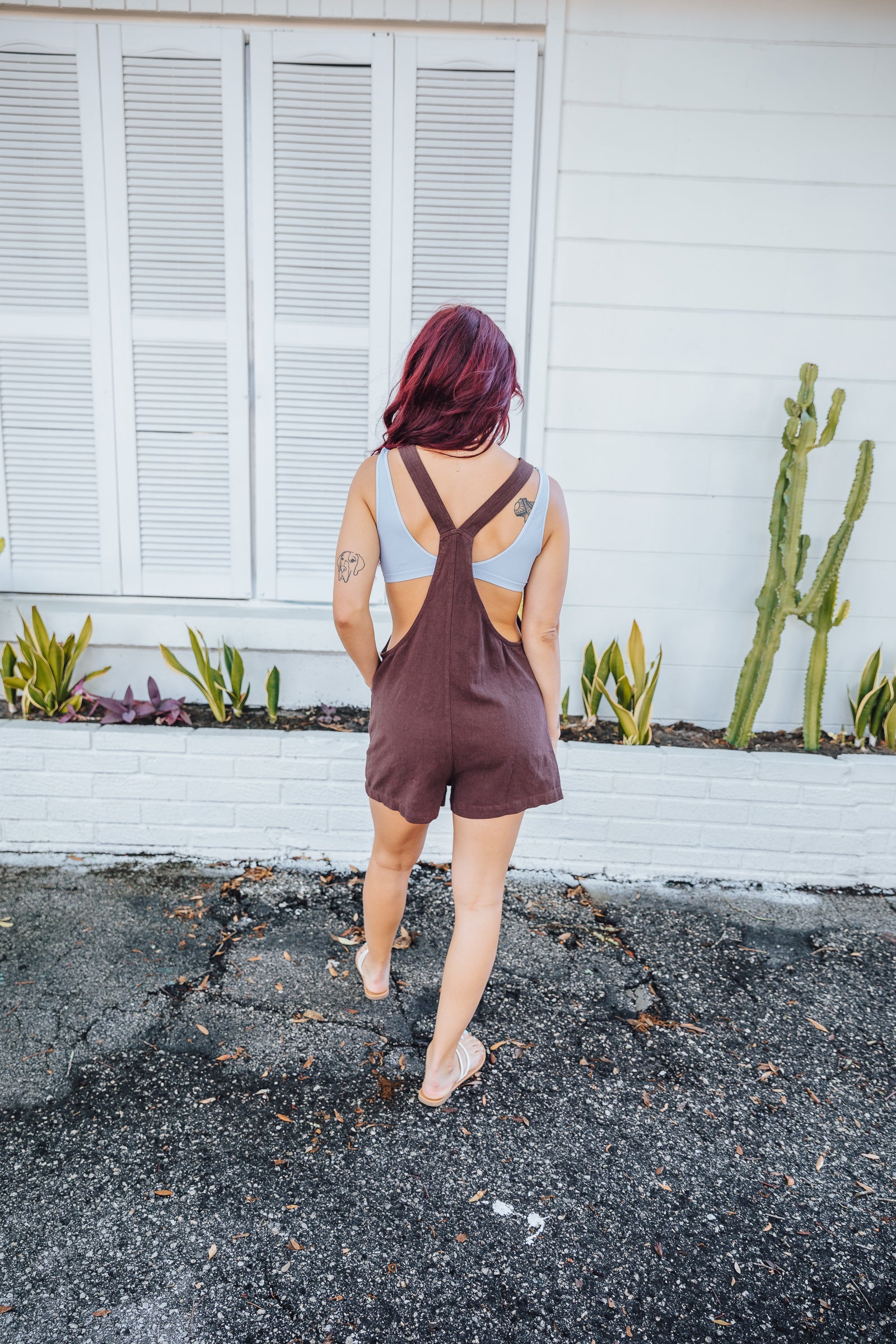 These trendy overalls have small straps that connect as knots to the straight neckline and have pockets along the bottom of the shorts. These brown overalls go perfect as a beach cover up.