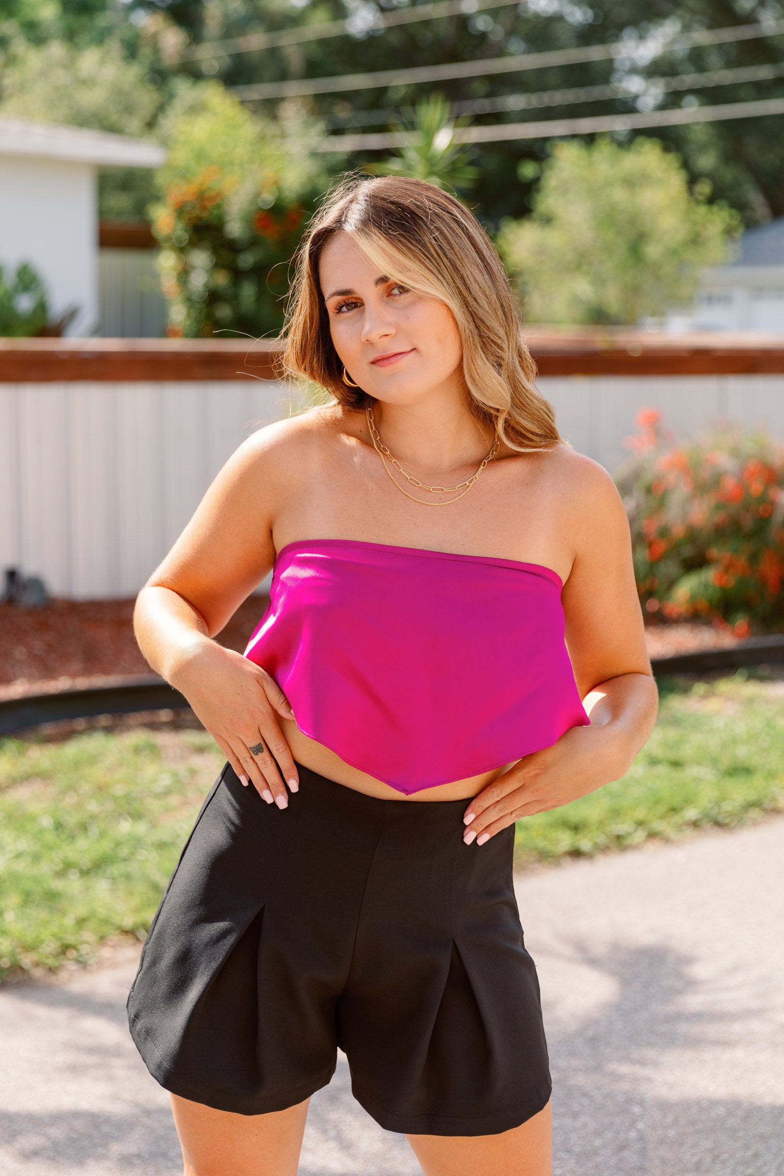 This pink top has a straight neckline and a bandana style cropped bodice. 