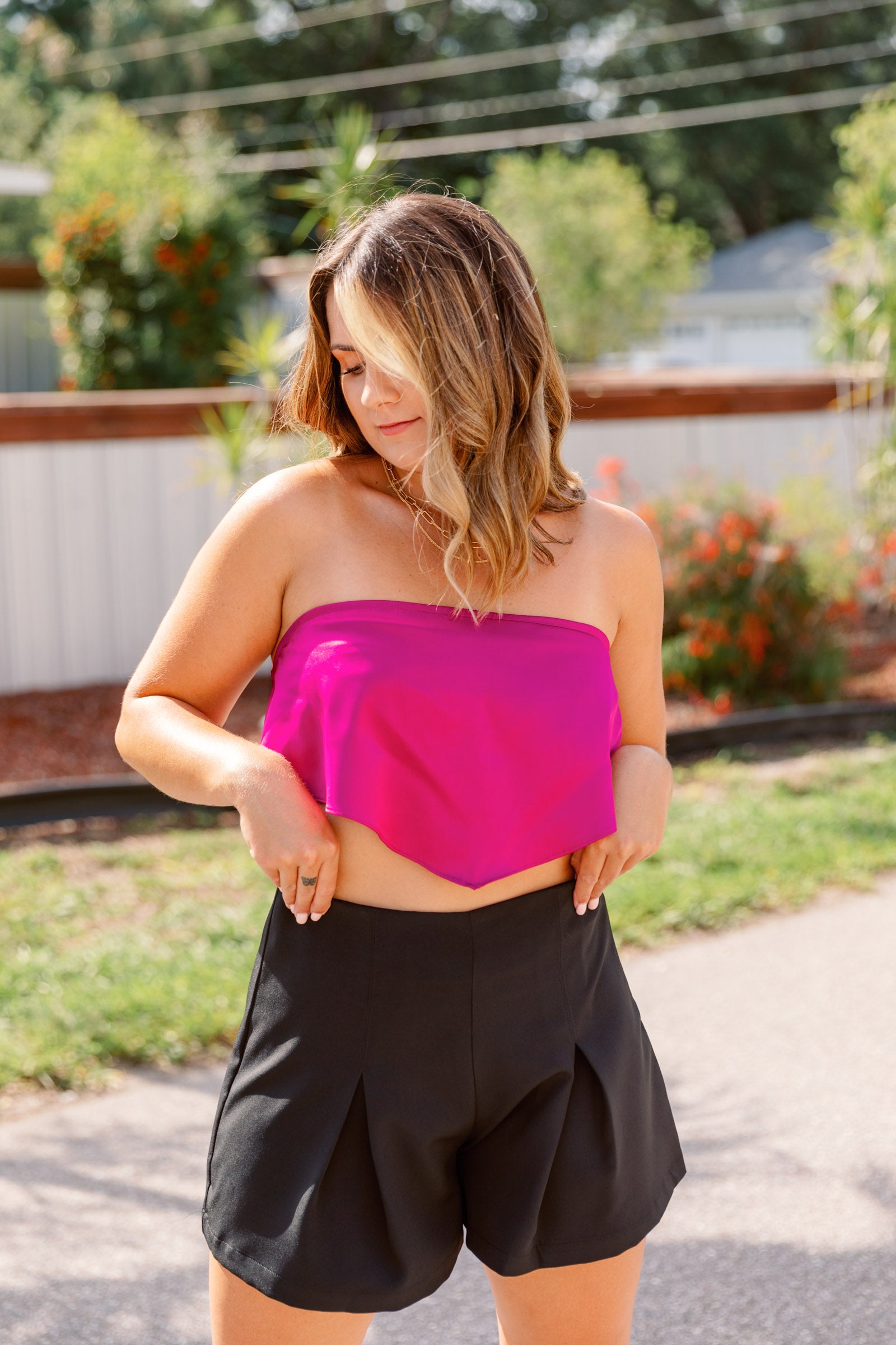 This pink top has a straight neckline and a bandana style cropped bodice. 