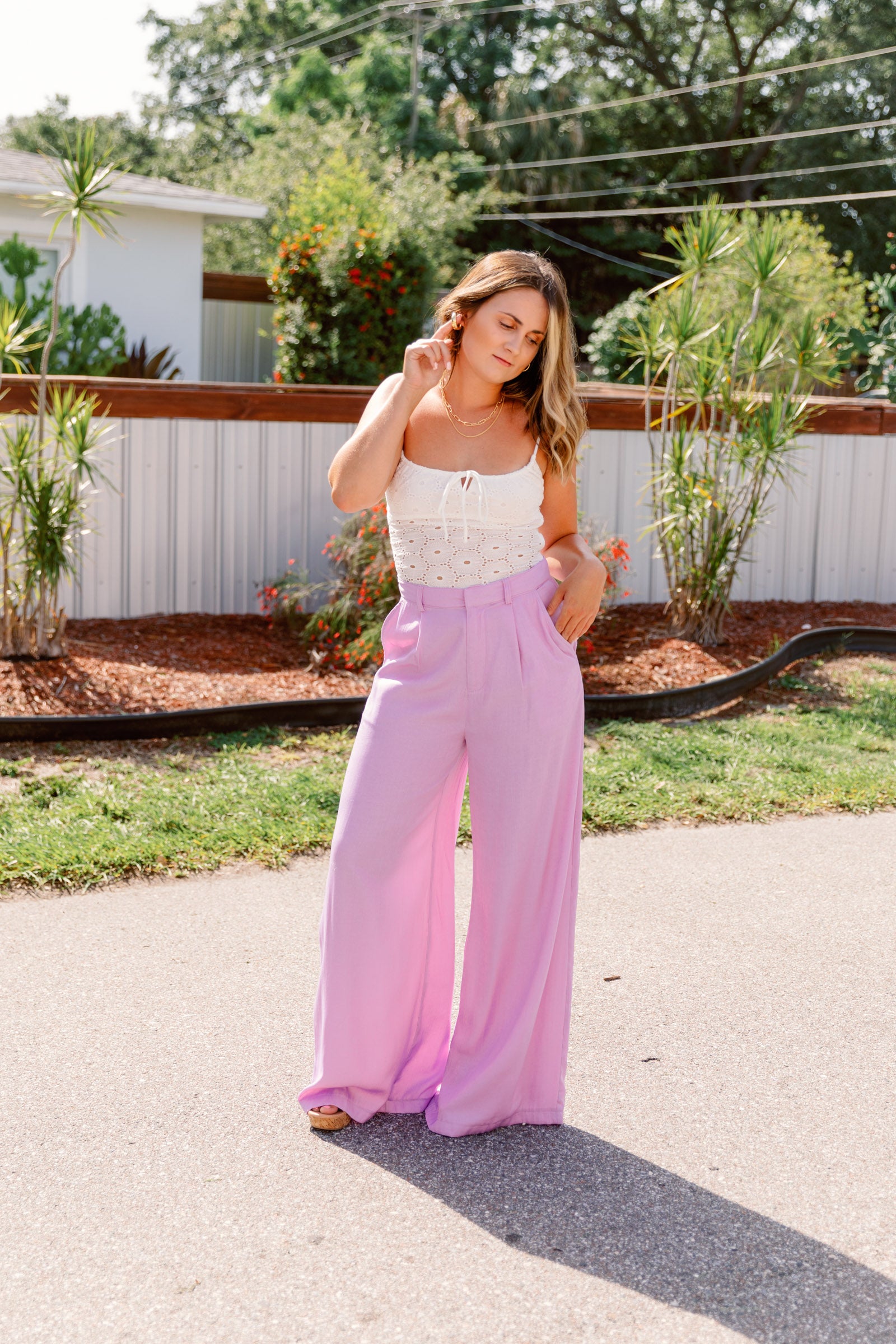 These light blue pants have a high waistband with attached pockets and a long flare cut. 
