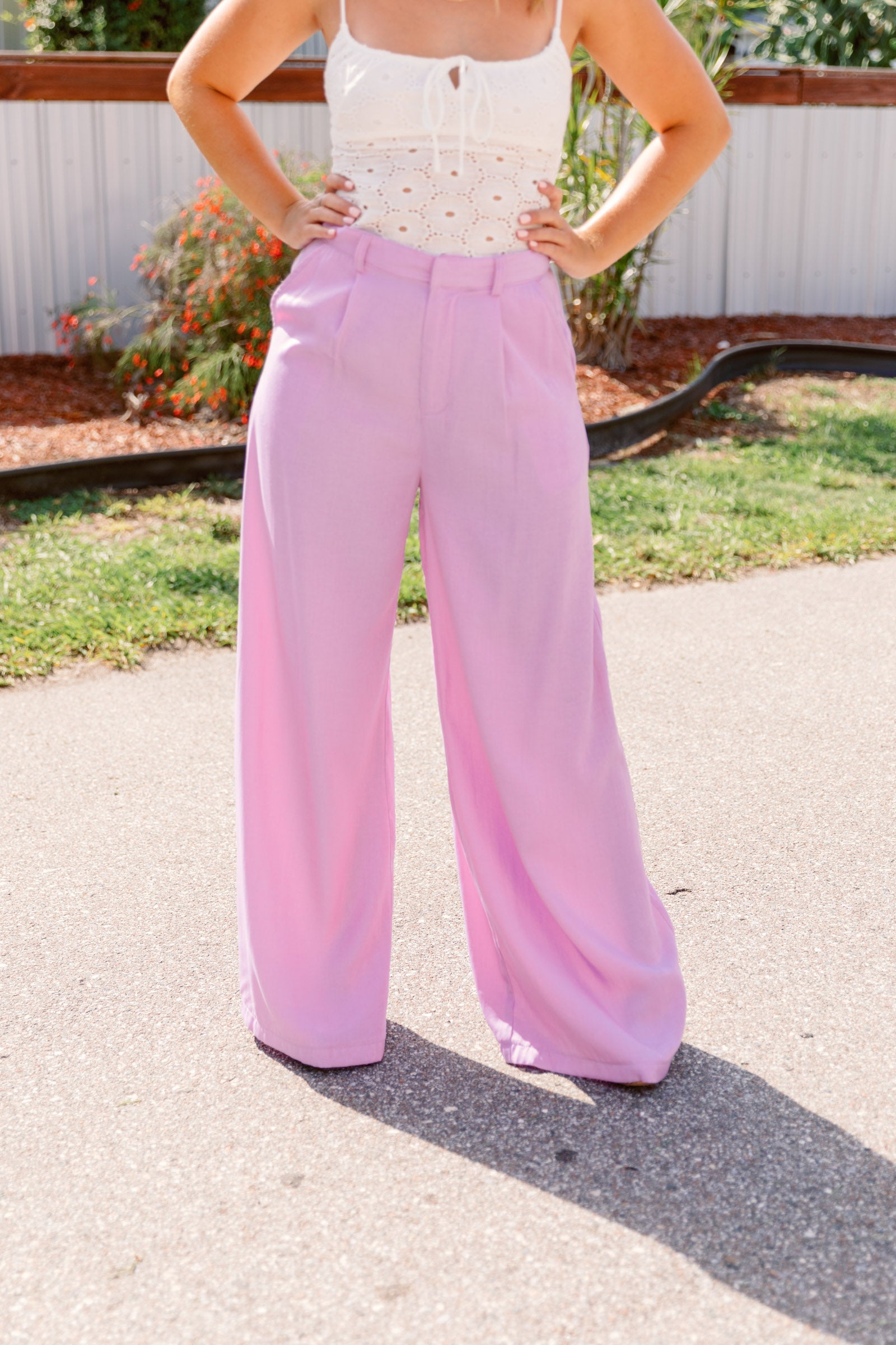 These light blue pants have a high waistband with attached pockets and a long flare cut. 